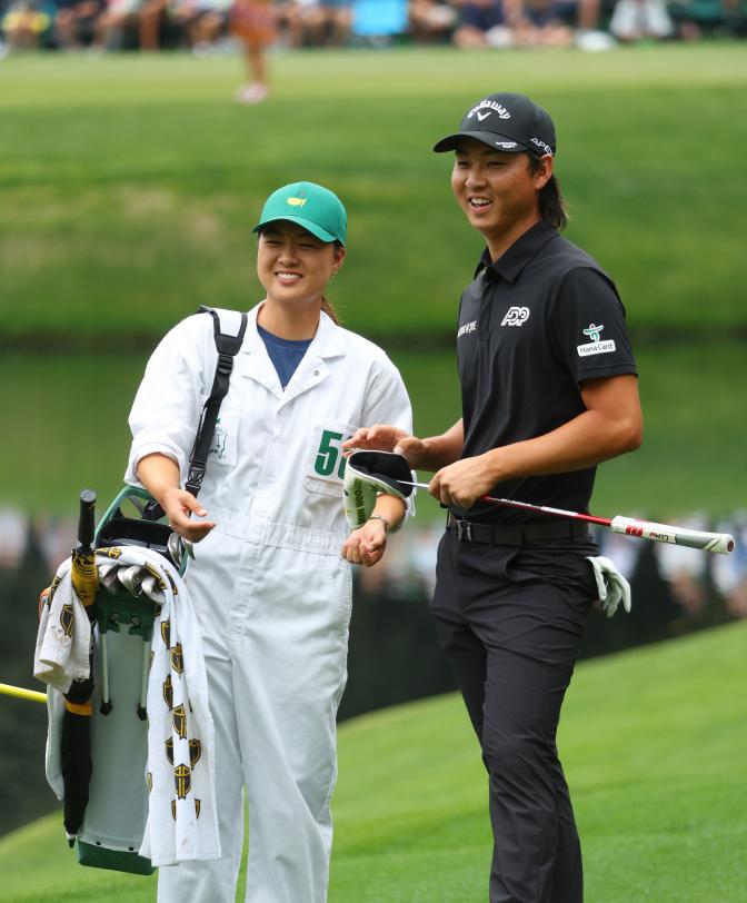 Min Woo Lee with his sister Minjee acting as his caddie.